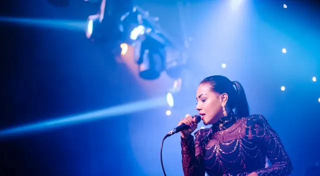 Radhika Rajavelu performing live under the stage lights